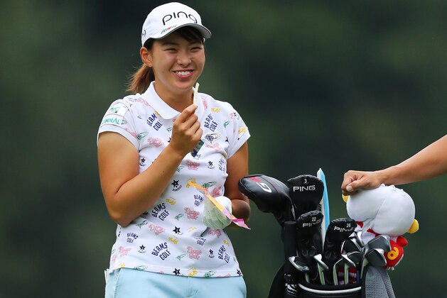 WOBURN, ENGLAND - AUGUST 04: Hinako Shibuno of Japan enjoys a snack on the 16th fairway during Day Four of the AIG Women's British Open at Woburn Golf Club on August 04, 2019 in Woburn, England. (Photo by Richard Heathcote/Getty Images)
