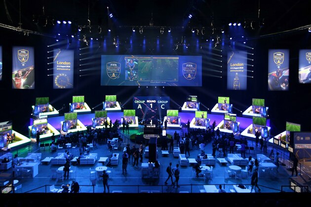 Players compete on Microsoft Xbox and Sony Playstation games consoles in the group stages of the FIFA eWorld Cup Grand Final, at the O2 in London on August 2, 2018. - The FIFA eWorld Cup Grand Final 2018 will see 32 finalists battle it out for the main prize  the title of FIFA eWorld Cup champion, and pocket USD 250,000 in prize money. (Photo by Daniel LEAL-OLIVAS / AFP)        (Photo credit should read DANIEL LEAL-OLIVAS/AFP/Getty Images)