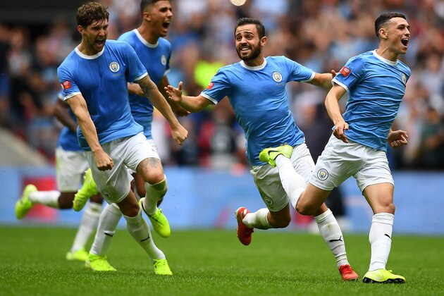 LONDON, ENGLAND - AUGUST 04: Bernardo Silva, Phil Foden and John Stones of Manchester City celebrate following their team's victory in the penalty shoot out during during the FA Community Shield match at Wembley Stadium on August 04, 2019 in London, England. (Photo by Clive Mason/Getty Images)