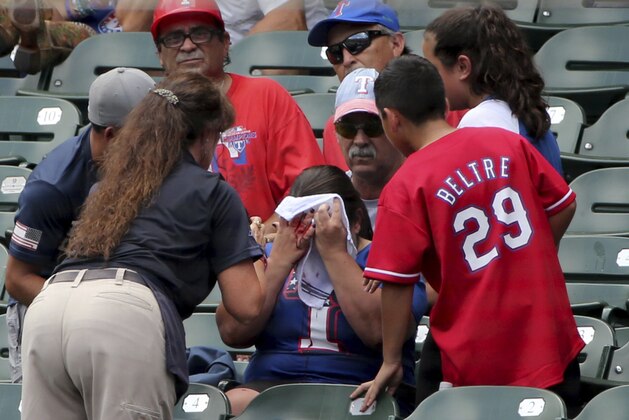 A fan is bloodied after a foul ball hit her off the bat of Texas Rangers left fielder Willie Calhoun during the first inning of a baseball game against the Detroit Tigers Sunday, August 4, 2019, in Arlington, Texas. (AP Photo/Michael Ainsworth)