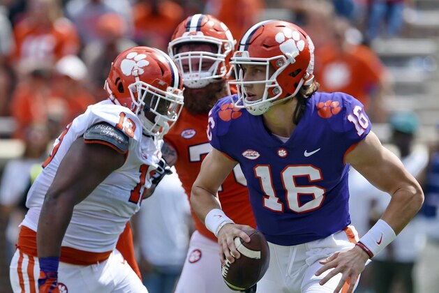 Clemson's Trevor Lawrence (16) scrambles out of the backfield during Clemson's annual Orange and White NCAA college football spring scrimmage Saturday, April 6, 2019, in Clemson, S.C. (AP Photo/Richard Shiro)