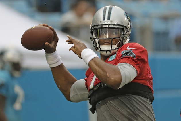 Carolina Panthers quarterback Cam Newton looks to pass during a Fan Fest practice at the NFL football team's training camp in Charlotte, N.C., Friday, Aug. 2, 2019. (AP Photo/Chuck Burton)