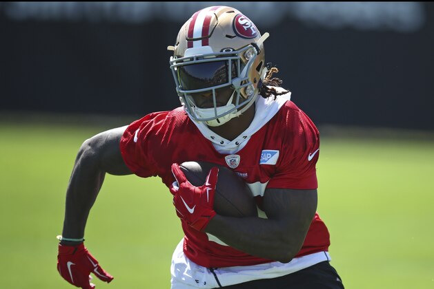 San Francisco 49ers running back Jerick McKinnon runs with the ball during NFL football practice at the team's headquarters Thursday, July 26, 2018, in Santa Clara, Calif. (AP Photo/Ben Margot)