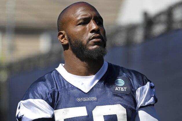 Dallas Cowboys defensive end Robert Quinn walks onto the field at the NFL football team's training camp in Oxnard, Calif., Saturday, July 27, 2019. (AP Photo/Michael Owen Baker)