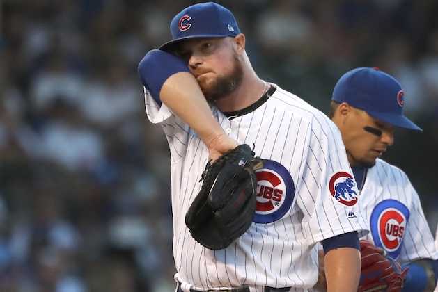 Chicago Cubs starting pitcher Jon Lester wipes his face after a mound visit by pitching coach Tommy Hottovy during the second inning of a baseball game against the Oakland Athletics Tuesday, Aug. 6, 2019, in Chicago. (AP Photo/Charles Rex Arbogast)