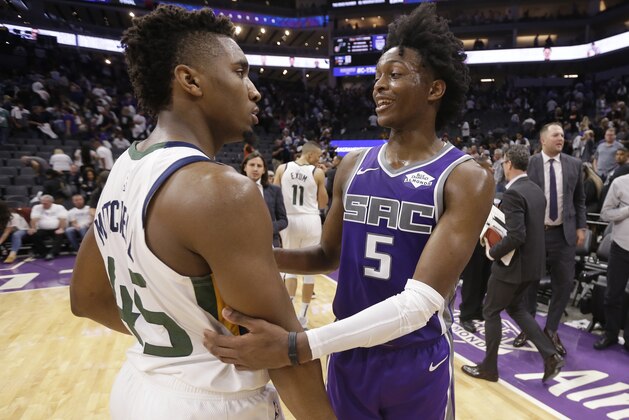 Utah Jazz guard Donovan Mitchell, left, and Sacramento Kings guard De'Aaron Fox talk after the Jazz defeated the Kings 123-117 in an NBA basketball game Wednesday, Oct. 17, 2018, in Sacramento, Calif.(AP Photo/Rich Pedroncelli)