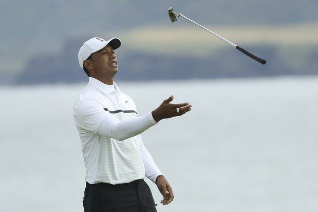 Tiger Woods of the United States throws his club in the air con the 5th green during the second round of the British Open Golf Championships at Royal Portrush in Northern Ireland, Friday, July 19, 2019.(AP Photo/Peter Morrison)