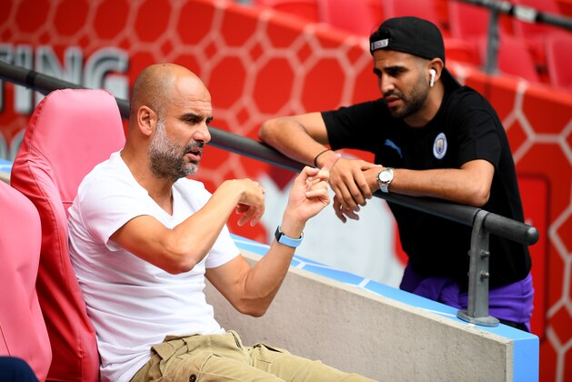 LONDON, ENGLAND - AUGUST 04: Pep Guardiola, Manager of Manchester City talks to Riyad Mahrez prior to the FA Community Shield match between Liverpool and Manchester City at Wembley Stadium on August 04, 2019 in London, England. (Photo by Clive Mason/Getty Images)