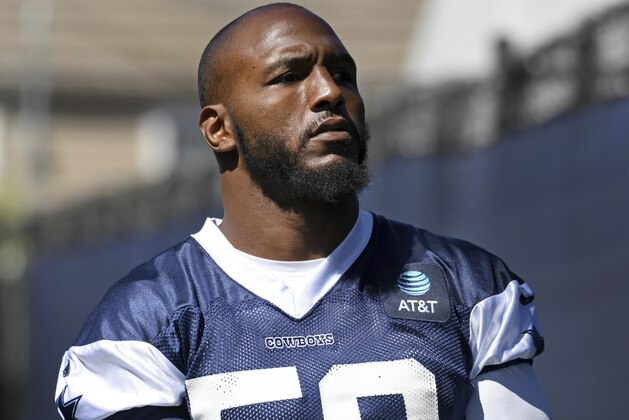 Dallas Cowboys defensive end Robert Quinn walks onto the field at the NFL football team's training camp in Oxnard, Calif., Saturday, July 27, 2019. (AP Photo/Michael Owen Baker)