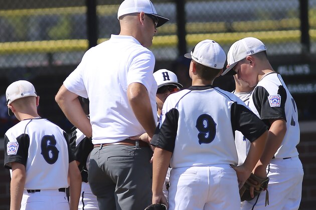 Hamilton pitching coach Brian Treadway visits the mound during a Little League regional tournament baseball game, Sunday Aug. 4 , 2019, in Westfield, Ind. (AP Photo/Tony Tribble)