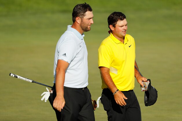 JERSEY CITY, NEW JERSEY - AUGUST 10: Jon Rahm of Spain and Patrick Reed of the United States react after finishing on the 18th green during the third round of The Northern Trust at Liberty National Golf Club on August 10, 2019 in Jersey City, New Jersey. (Photo by Kevin C. Cox/Getty Images)