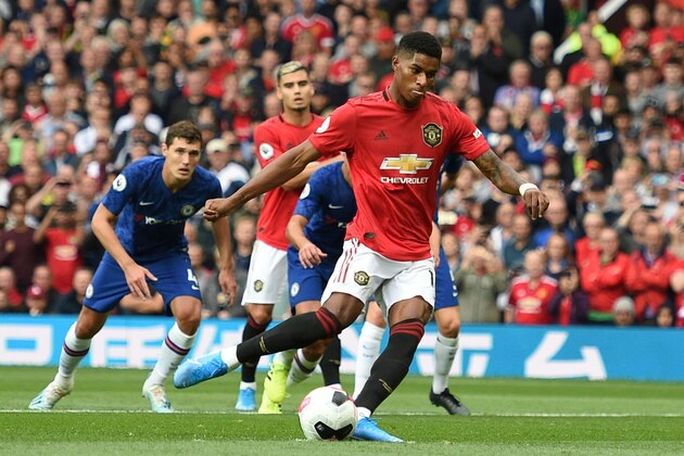 Manchester United's English striker Marcus Rashford (C) shoots to score from the penalty spot for the opening goal during the English Premier League football match between Manchester United and Chelsea at Old Trafford in Manchester, north west England, on August 11, 2019. (Photo by Oli SCARFF / AFP) / RESTRICTED TO EDITORIAL USE. No use with unauthorized audio, video, data, fixture lists, club/league logos or 'live' services. Online in-match use limited to 120 images. An additional 40 images may be used in extra time. No video emulation. Social media in-match use limited to 120 images. An additional 40 images may be used in extra time. No use in betting publications, games or single club/league/player publications. /         (Photo credit should read OLI SCARFF/AFP/Getty Images)