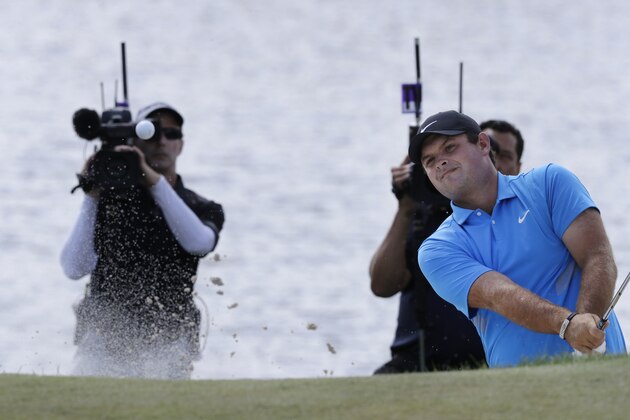 Patrick Reed hits out of a bunker on the fourth hole in the final round of the Northern Trust golf tournament at Liberty National Golf Course, Sunday, Aug. 11, 2019, in Jersey City, N.J. (AP Photo/Mark Lennihan)