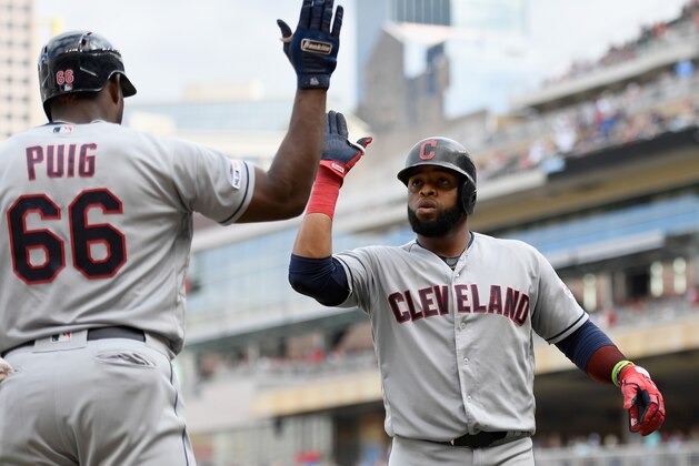 MINNEAPOLIS, MN - AUGUST 11: Yasiel Puig #66 of the Cleveland Indians congratulates teammate Carlos Santana #41 on a grand slam against the Minnesota Twins during the tenth inning of the game on August 11, 2019 at Target Field in Minneapolis, Minnesota. The Indians defeated the Twins 7-3 in ten innings. (Photo by Hannah Foslien/Getty Images)