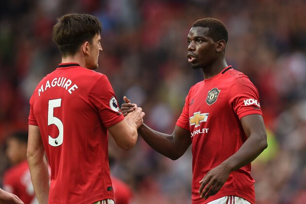 Manchester United's English defender Harry Maguire (L) shakes hands with Manchester United's French midfielder Paul Pogba (R) on the pitch at the final whistle in the English Premier League football match between Manchester United and Chelsea at Old Trafford in Manchester, north west England, on August 11, 2019. - Manchester United won the game 4-0. (Photo by Oli SCARFF / AFP) / RESTRICTED TO EDITORIAL USE. No use with unauthorized audio, video, data, fixture lists, club/league logos or 'live' services. Online in-match use limited to 120 images. An additional 40 images may be used in extra time. No video emulation. Social media in-match use limited to 120 images. An additional 40 images may be used in extra time. No use in betting publications, games or single club/league/player publications. /         (Photo credit should read OLI SCARFF/AFP/Getty Images)