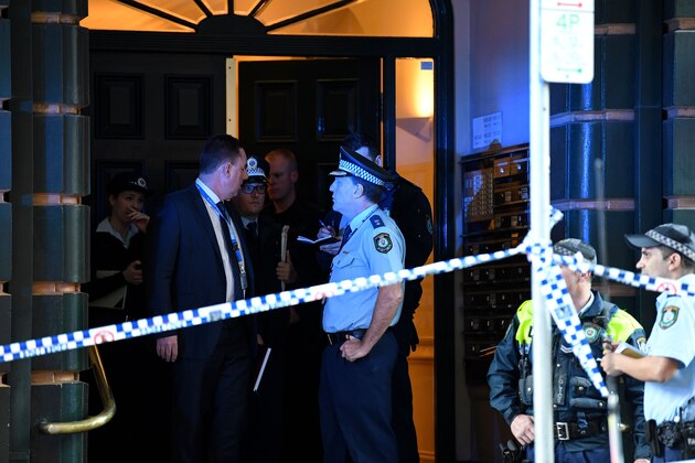 Police investigate inside a building near the scene of a knife rampage in Sydney on August 13, 2019. - Australian police said they had discovered a body near the scene of a knife rampage in central Sydney on Tuesday, but were still determining whether it was linked to the attack. (Photo by Saeed KHAN / AFP)        (Photo credit should read SAEED KHAN/AFP/Getty Images)