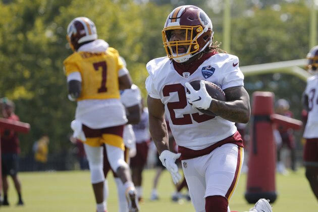 Washington Redskins running back Derrius Guice (29) runs a drill during the NFL football training camp in Richmond, Va., Friday, July 26, 2019. (AP Photo/Steve Helber)