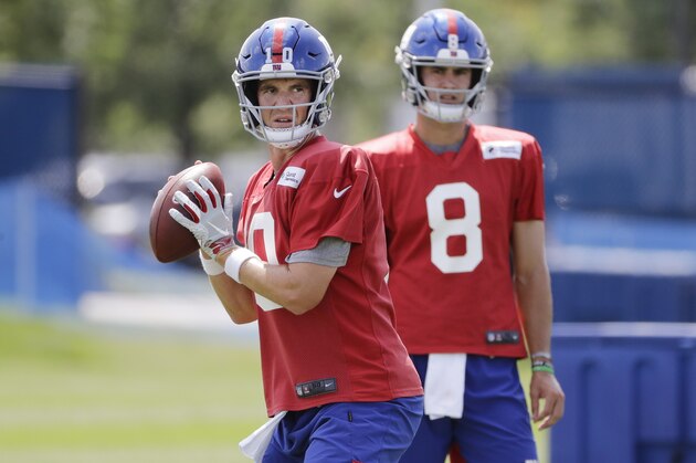 New York Giants' quarterback Daniel Jones watches as Eli Manning throws a pass at the NFL football team's training camp in Thursday, July 25, 2019, in East Rutherford, N.J. (AP Photo/Frank Franklin II)