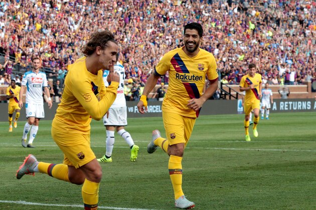 FC Barcelona's Luis Suarez (R) celebrates his goal with teammate Antoine Griezmann during the second half of the La Liga-Serie A Cup match between FC Barcelona and SSC Napoli on August 10, 2019 at Michigan Stadium in Ann Arbor, Michigan. (Photo by JEFF KOWALSKY / AFP)        (Photo credit should read JEFF KOWALSKY/AFP/Getty Images)