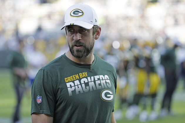Green Bay Packers quarterback Aaron Rodgers talks with teammates before the start of an NFL preseason football game against the Houston Texans Thursday, Aug. 8, 2019, in Green Bay, Wis. (AP Photo/Mike Roemer)