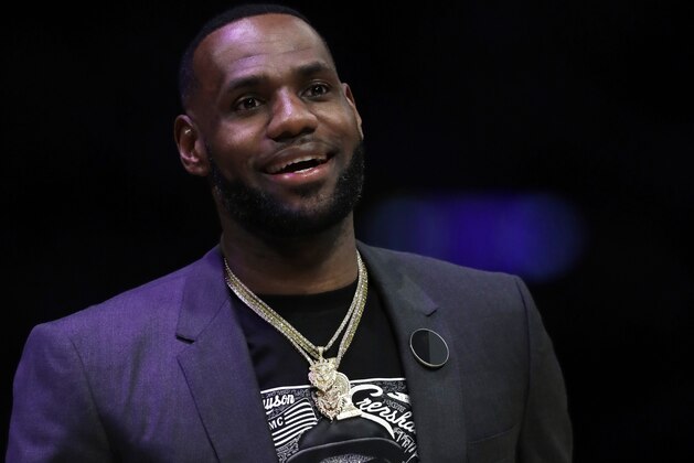 Los Angeles Lakers' LeBron James wears a t-shirt with the likeness of slain rapper Nipsey Hussle during the second half of an NBA basketball game against the Golden State Warriors Thursday, April 4, 2019, in Los Angeles. (AP Photo/Marcio Jose Sanchez)