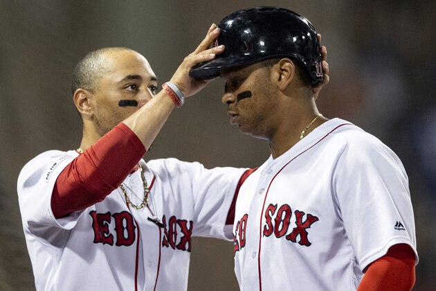 BOSTON, MA - JULY 17: Rafael Devers #11 of the Boston Red Sox has his helmet removed by Mookie Betts #50 after hitting a go-ahead solo home run during the third inning of a game against the Toronto Blue Jays on July 17, 2019 at Fenway Park in Boston, Massachusetts. (Photo by Billie Weiss/Boston Red Sox/Getty Images)
