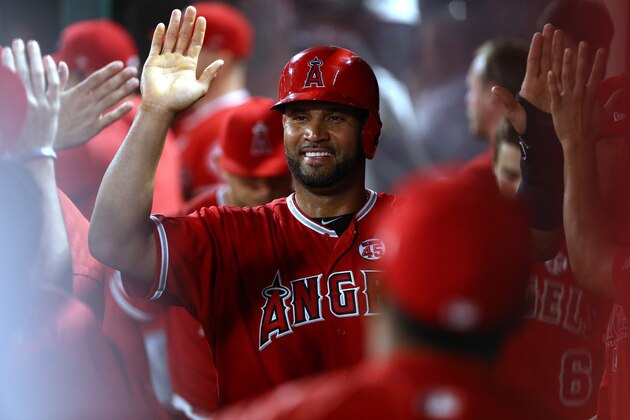 ANAHEIM, CALIFORNIA - AUGUST 14: Albert Pujols #5 of the Los Angeles Angels celebrates with teammates in the dugout after scoring in the eighth inning of the MLB game against the Pittsburgh Pirates at Angel Stadium of Anaheim on August 14, 2019 in Anaheim, California. The Angels defeated the Pirates 7-4. (Photo by Victor Decolongon/Getty Images)
