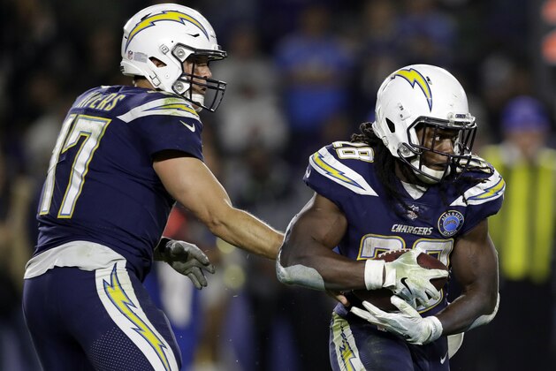 Los Angeles Chargers running back Melvin Gordon (28) gets a hand off from quarterback Philip Rivers from during an NFL football game against the Baltimore Ravens Saturday, Dec. 22, 2018, in Carson, Calif. (AP Photo/Marcio Jose Sanchez)