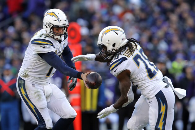 Los Angeles Chargers quarterback Philip Rivers, left, hands off to running back Melvin Gordon in the second half of an NFL wild card playoff football game against the Baltimore Ravens, Sunday, Jan. 6, 2019, in Baltimore. (AP Photo/Carolyn Kaster)