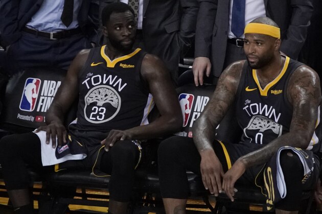 Golden State Warriors forward Draymond Green (23) sits on the bench next to center DeMarcus Cousins (0) and guard Stephen Curry (30) during the second half of Game 6 of basketball's NBA Finals against the Toronto Raptors in Oakland, Calif., Thursday, June 13, 2019. (AP Photo/Tony Avelar)