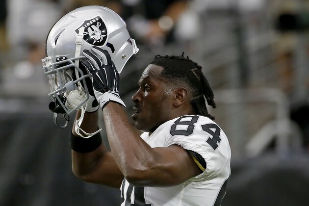 Oakland Raiders wide receiver Antonio Brown (84) puts on his helmet prior to an NFL football game against the Arizona Cardinals, Thursday, Aug. 15, 2019, in Glendale, Ariz. (AP Photo/Rick Scuteri)