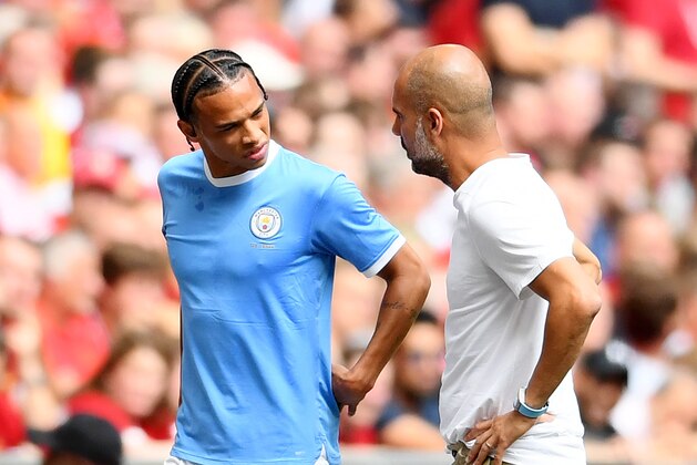 LONDON, ENGLAND - AUGUST 04: Pep Guardiola, Manager of Manchester City talks to Leroy Sane of Manchester City as he leaves the pitch with an injury during the FA Community Shield match between Liverpool and Manchester City at Wembley Stadium on August 04, 2019 in London, England. (Photo by Clive Mason/Getty Images)