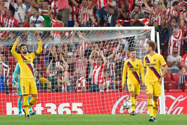 Barcelona's Spanish defender Gerard Pique (L) reacts to Athletic's goal during the Spanish league football match between Athletic Club Bilbao and FC Barcelona at the San Mames stadium in Bilbao on August 16, 2019. (Photo by ANDER GILLENEA / AFP)        (Photo credit should read ANDER GILLENEA/AFP/Getty Images)