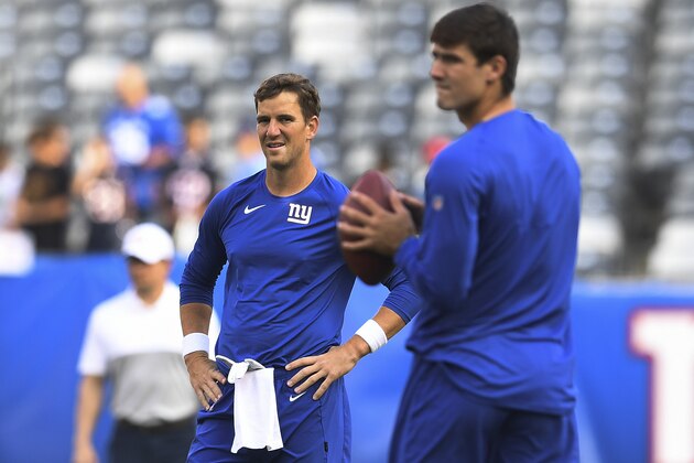 New York Giants quarterback Eli Manning, left, and New York Giants quarterback Daniel Jones, left, warm up before an NFL football game against the Chicago Bears, Friday, Aug. 16, 2019, in East Rutherford, N.J. (AP Photo/Sarah Stier)