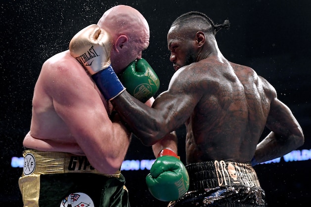 LOS ANGELES, CA - DECEMBER 01:  Deontay Wilder and Tyson Fury punch each other in the ninth round fighting to a draw during the WBC Heavyweight Championship at Staples Center on December 1, 2018 in Los Angeles, California.  (Photo by Harry How/Getty Images)