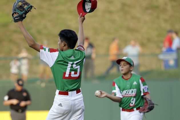 Mexico starting pitcher Santiago Leija (15) and Daniel Orozco (9) celebrate after the final out of a baseball game against British Columbia in the Little League World Series in South Williamsport, Pa., Friday, Aug. 16, 2019. (AP Photo/Tom E. Puskar)