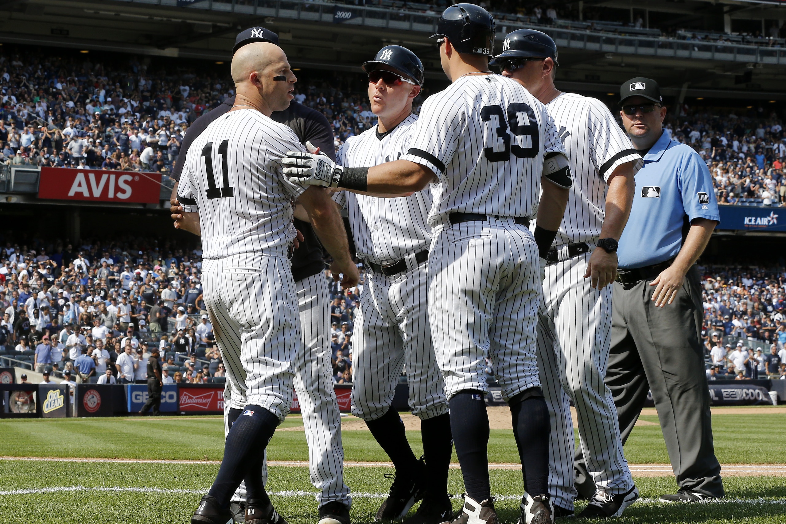 NEW YORK, NEW YORK - AUGUST 17:   Brett Gardner #11 of the New York Yankees is restrained by teammates as he argues with the umpires after his sixth inning ejection against the Cleveland Indians at Yankee Stadium on August 17, 2019 in New York City. (Photo by Jim McIsaac/Getty Images)