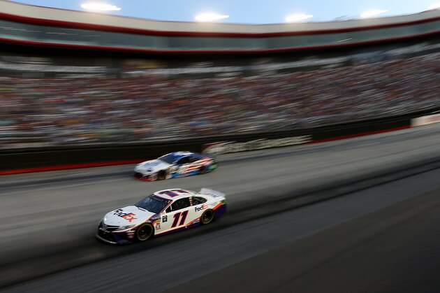 BRISTOL, TENNESSEE - AUGUST 17: Denny Hamlin, driver of the #11 FedEx Freight Toyota, leads a pack of cars during the Monster Energy NASCAR Cup Series Bass Pro Shops NRA Night Race at Bristol Motor Speedway on August 17, 2019 in Bristol, Tennessee. (Photo by Brian Lawdermilk/Getty Images)