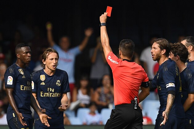 VIGO, SPAIN - AUGUST 17: Estrada Fernandez, the referee, shows a red card to Luka Modric of Real Madrid during the Liga match between RC Celta de Vigo and Real Madrid CF at Abanca-Balaídos on August 17, 2019 in Vigo, Spain. (Photo by Octavio Passos/Getty Images)