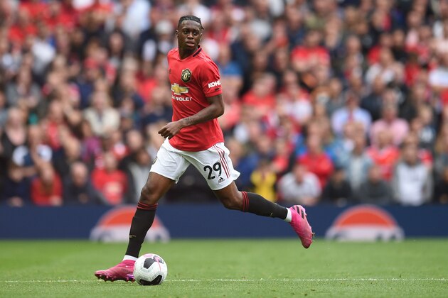 Manchester United's defender Aaron Wan-Bissaka runs with the ball on his premier league debut during the English Premier League football match between Manchester United and Chelsea at Old Trafford in Manchester, north west England, on August 11, 2019. (Photo by Oli SCARFF / AFP) / RESTRICTED TO EDITORIAL USE. No use with unauthorized audio, video, data, fixture lists, club/league logos or 'live' services. Online in-match use limited to 120 images. An additional 40 images may be used in extra time. No video emulation. Social media in-match use limited to 120 images. An additional 40 images may be used in extra time. No use in betting publications, games or single club/league/player publications. /         (Photo credit should read OLI SCARFF/AFP/Getty Images)