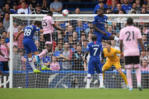 Leicester City's Nigerian midfielder Wilfred Ndidi (2L) jumps to scores the equalising goal during the English Premier League football match between Chelsea and Leicester City at Stamford Bridge in London on August 18, 2019. (Photo by Daniel LEAL-OLIVAS / AFP) / RESTRICTED TO EDITORIAL USE. No use with unauthorized audio, video, data, fixture lists, club/league logos or 'live' services. Online in-match use limited to 120 images. An additional 40 images may be used in extra time. No video emulation. Social media in-match use limited to 120 images. An additional 40 images may be used in extra time. No use in betting publications, games or single club/league/player publications. /         (Photo credit should read DANIEL LEAL-OLIVAS/AFP/Getty Images)
