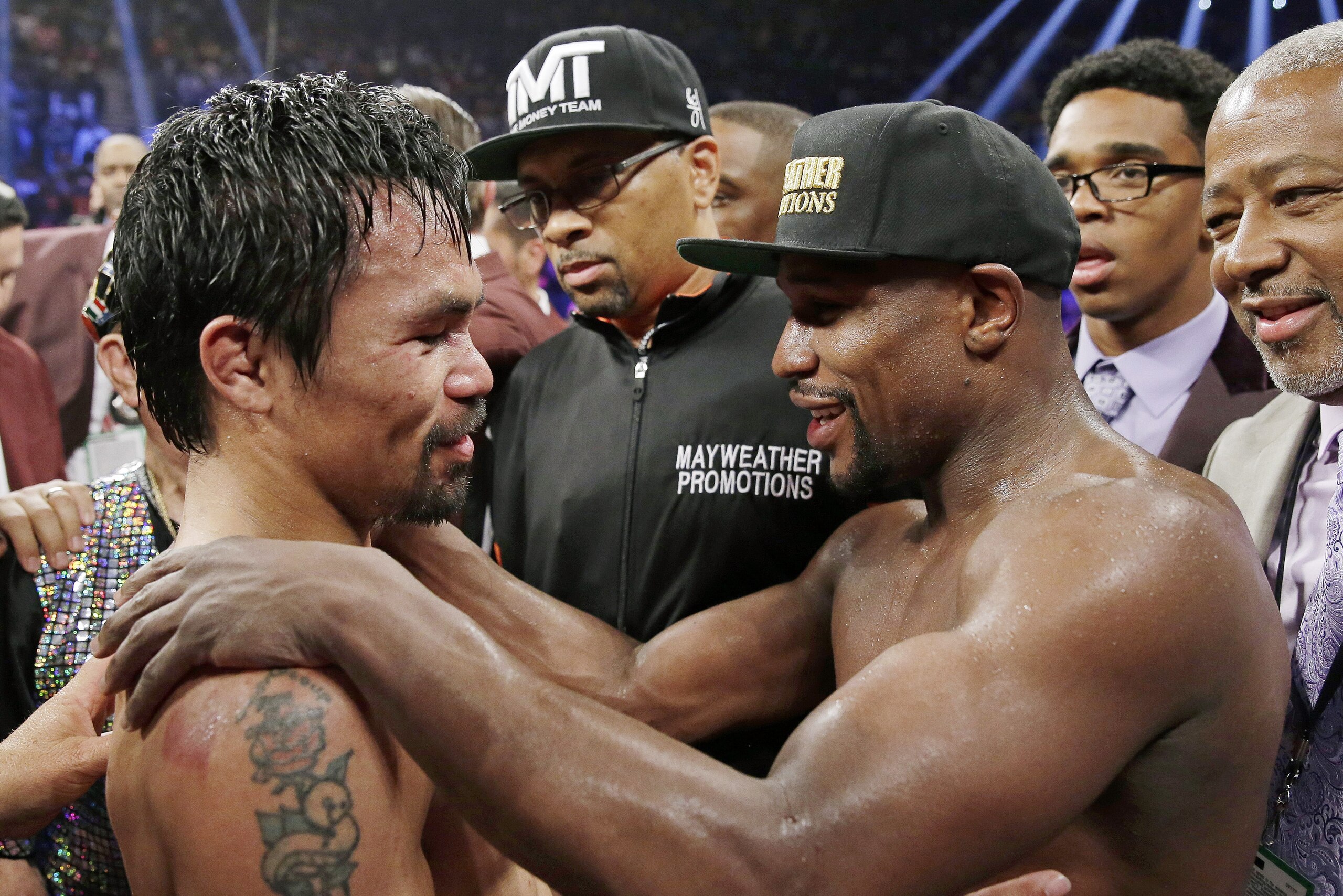 FILE - This May 2, 2015 file photo shows Manny Pacquiao from the Philippines, left, and Floyd Mayweather Jr., embracing in the ring at the finish of their welterweight title fight in Las Vegas. A federal judge Friday, Aug. 25, 2017 dismissed class-action lawsuits by disgruntled boxing fans around the country who complained they didn't get their pay-per-view money's worth in the fight. The judge said that he felt sympathy for fans who felt deceived that Pacquiao's camp failed to disclose he had a shoulder injury until about three hours before the fight. (AP Photo/Isaac Brekken,File) FILE - This May 2, 2015 file photo shows Manny Pacquiao from the Philippines, left, and Floyd Mayweather Jr., embracing in the ring at the finish of their welterweight title fight in Las Vegas. A federal judge Friday, Aug. 25, 2017 dismissed class-action lawsuits by disgruntled boxing fans around the country who complained they didn't get their pay-per-view money's worth in the fight. The judge said that he felt sympathy for fans who felt deceived that Pacquiao's camp failed to disclose he had a shoulder injury until about three hours before the fight. (AP Photo/Isaac Brekken,File)