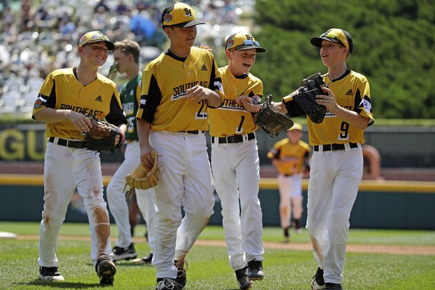 South Riding, Virginia pitcher Justin Lee (22) celebrates as he walks off the field with Chase Obstgarten, left, Matt Colman (1), and Colton Hicks (9) getting the final out of the fourth inning and an 11-0 win over Coon Rapids, Minnesota in a baseball game at the Little League World Series tournament in South Williamsport, Pa., Sunday, Aug. 18, 2019. (AP Photo/Gene J. Puskar)