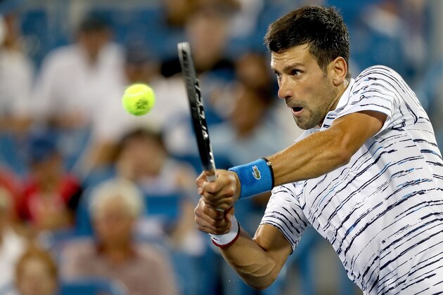 MASON, OHIO - AUGUST 16: Novak Djokovic of Serbia returns a shot to Lucas Pouille of France  during the Western & Southern Open at Lindner Family Tennis Center on August 16, 2019 in Mason, Ohio. (Photo by Matthew Stockman/Getty Images)