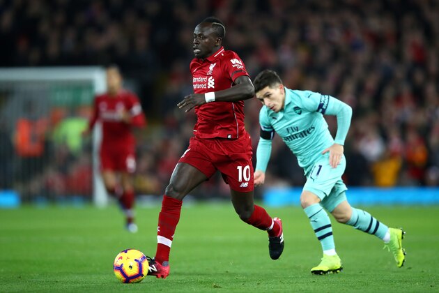 LIVERPOOL, ENGLAND - DECEMBER 29:  Sadio Mane of Liverpool goes past Lucas Torreira of Arsenal during the Premier League match between Liverpool FC and Arsenal FC at Anfield on December 29, 2018 in Liverpool, United Kingdom.  (Photo by Clive Brunskill/Getty Images)