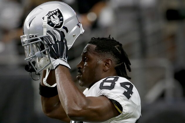 Oakland Raiders wide receiver Antonio Brown (84) puts on his helmet prior to an NFL football game against the Arizona Cardinals, Thursday, Aug. 15, 2019, in Glendale, Ariz. (AP Photo/Rick Scuteri)