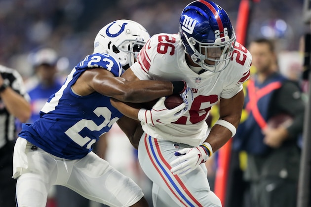 Indianapolis Colts cornerback Kenny Moore (23) tries to strip the ball from New York Giants running back Saquon Barkley (26) during the first half of an NFL football game in Indianapolis, Sunday, Dec. 23, 2018. (AP Photo/AJ Mast)