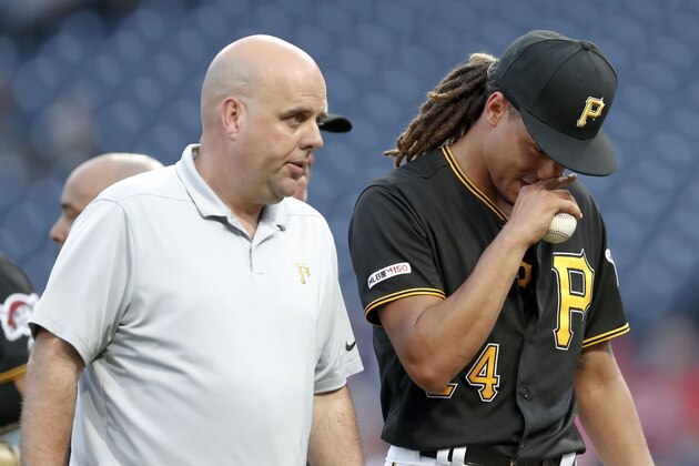 Pittsburgh Pirates starting pitcher Chris Archer, right, leaves the field with trainer Bryan Housand before the start of the second inning in a baseball game against the Washington Nationals, Tuesday, Aug. 20, 2019, in Pittsburgh. (AP Photo/Keith Srakocic)