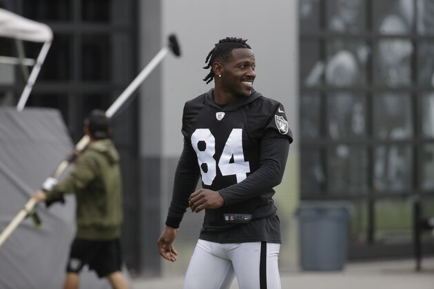 Oakland Raiders' Antonio Brown smiles before stretching during NFL football practice in Alameda, Calif., Tuesday, Aug. 20, 2019. (AP Photo/Jeff Chiu)