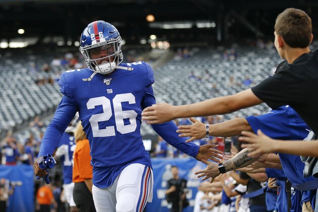 New York Giants running back Saquon Barkley (26) greets fans before an NFL football game against the Chicago Bears, Friday, Aug. 16, 2019, in East Rutherford, N.J. (AP Photo/Adam Hunger)